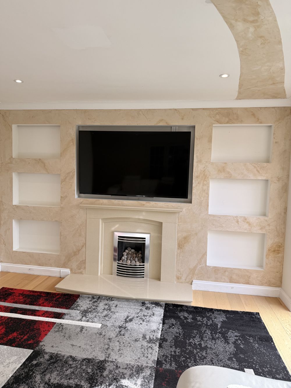 Cream marble-effect media wall with display niches