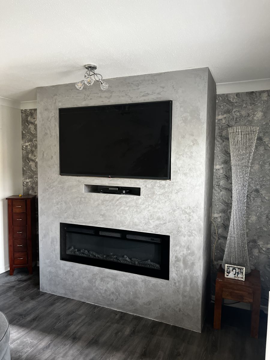 Silver Venetian plaster media wall with TV and inset fire