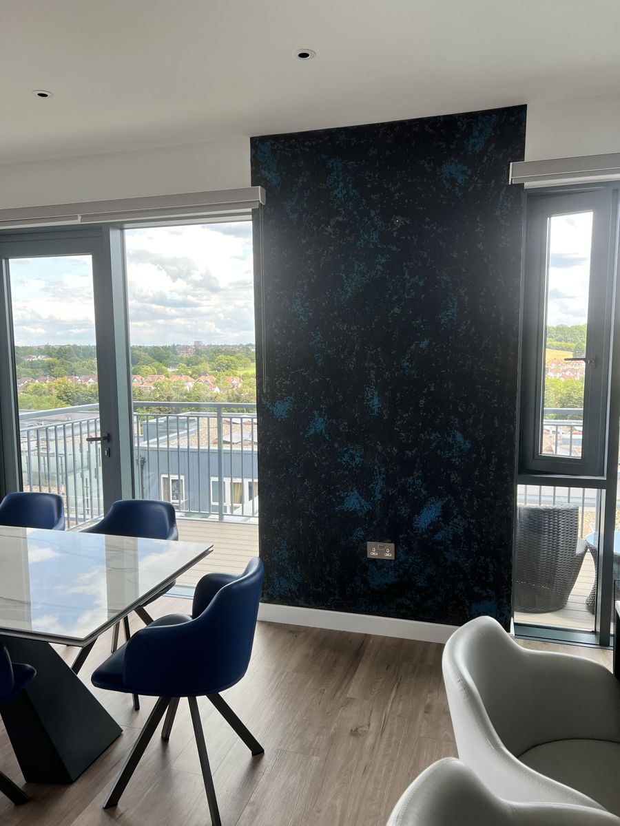 Black and blue metallic plaster feature wall in a dining room