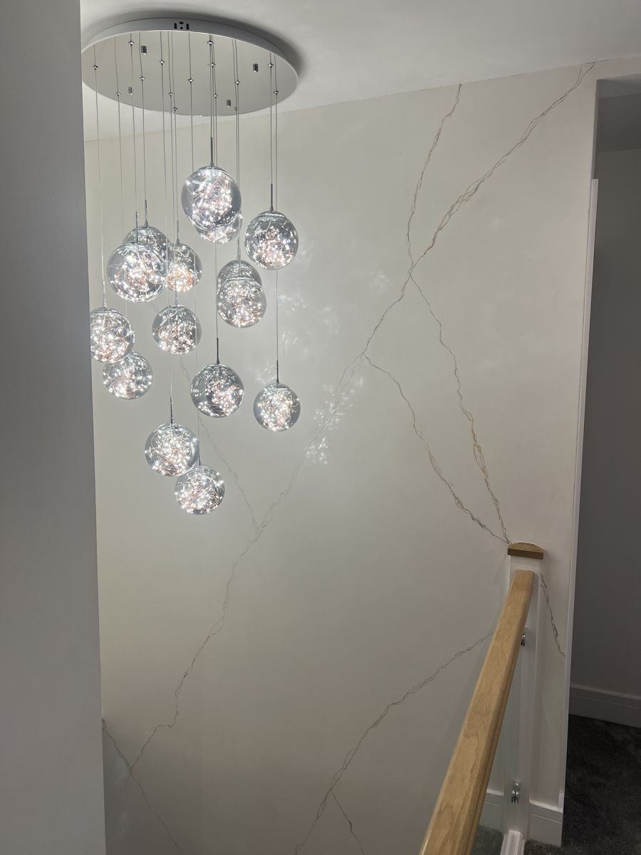 Glossy white marble-effect plaster up a staircase with gold veining